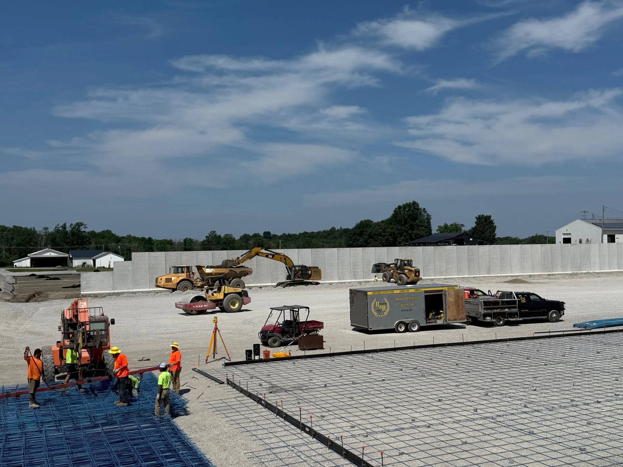 R&R crews, reinforcement and equipment preparing a large concrete slab